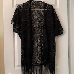 Black knitted kimono with tassels.